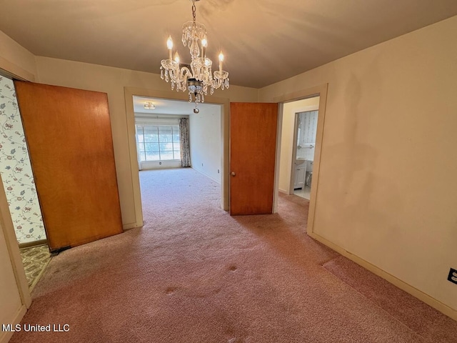 unfurnished dining area with a chandelier, carpet flooring, and baseboards