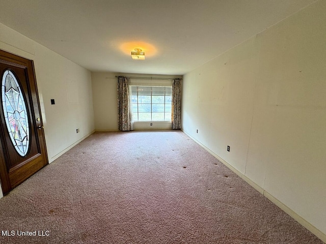 entrance foyer with carpet and baseboards