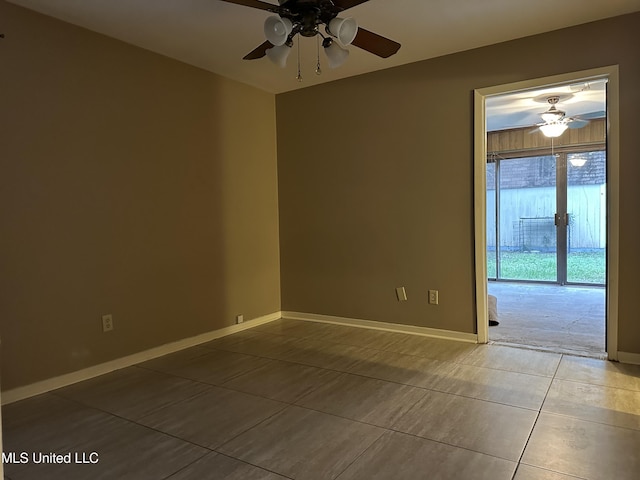 spare room with tile patterned floors and ceiling fan