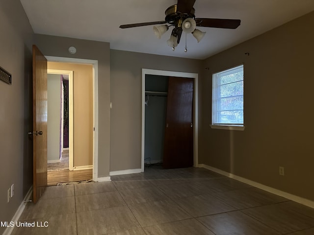 unfurnished bedroom with a closet and ceiling fan