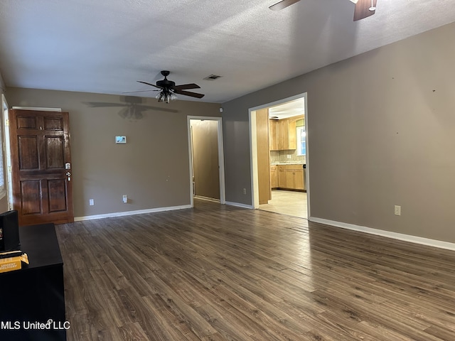 unfurnished living room featuring ceiling fan, wood-type flooring, and a textured ceiling