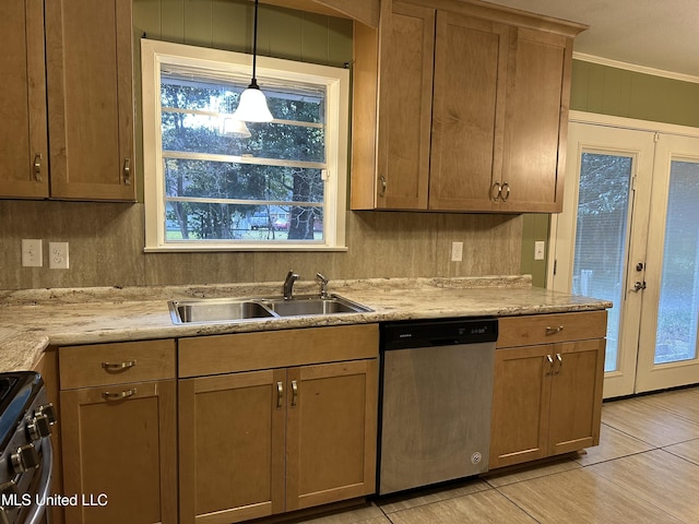 kitchen with french doors, stainless steel appliances, crown molding, sink, and pendant lighting