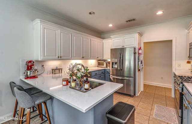 865 Wellington Way, Madison, MS 39110 - kitchen featuring stainless steel appliances, backsplash, white cabinets, a peninsula, and crown molding