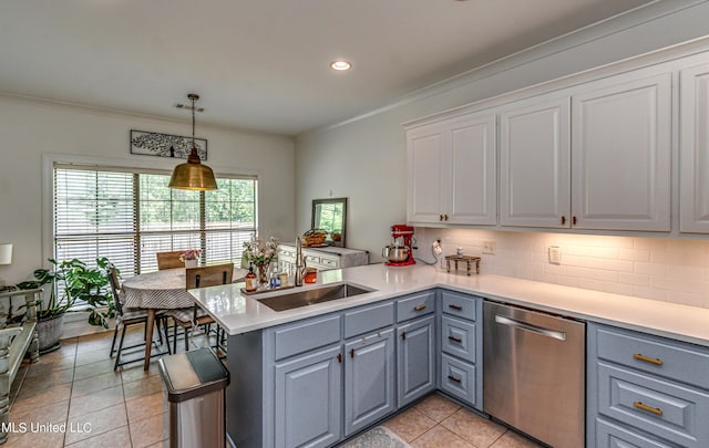 865 Wellington Way, Madison, MS 39110 - kitchen featuring stainless steel dishwasher, a sink, a peninsula, light tile patterned floors, and light countertops