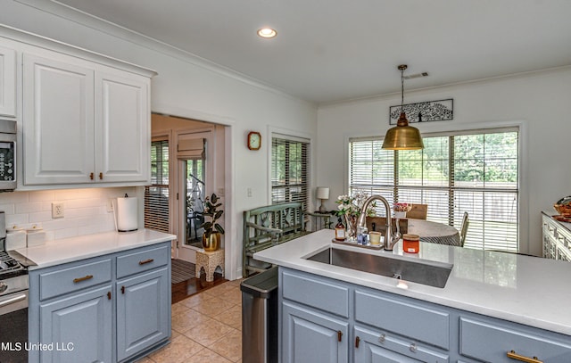 865 Wellington Way, Madison, MS 39110 - kitchen with a sink, ornamental molding, gray cabinets, decorative light fixtures, and appliances with stainless steel finishes