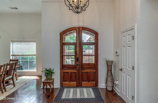 865 Wellington Way, Madison, MS 39110 - foyer entrance with plenty of natural light, dark wood-style floors, a towering ceiling, a chandelier, and ornamental molding