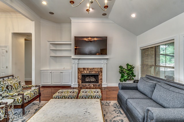 865 Wellington Way, Madison, MS 39110 - living room with a chandelier, dark wood-type flooring, a premium fireplace, baseboards, and vaulted ceiling