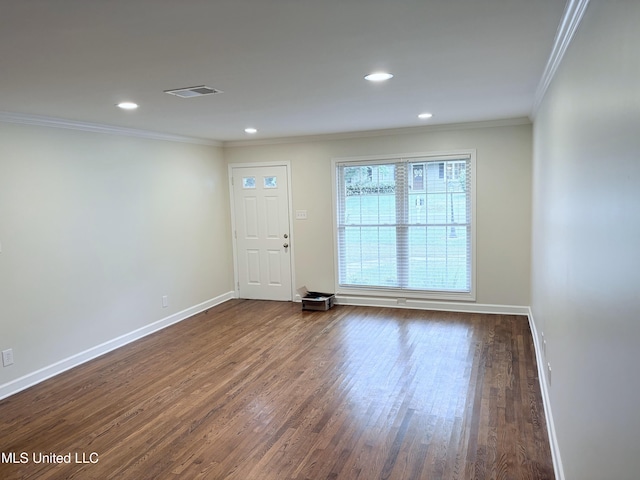 spare room featuring visible vents, crown molding, wood finished floors, baseboards, and recessed lighting
