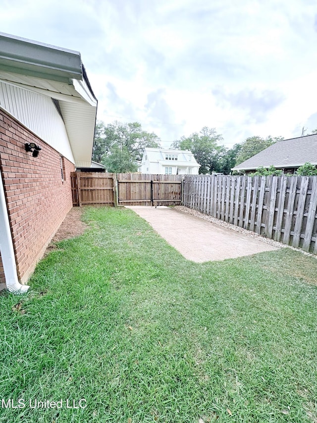 view of yard with a patio and a fenced backyard