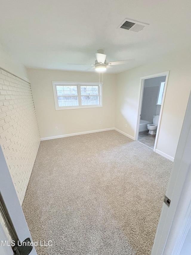 unfurnished bedroom featuring carpet floors, baseboards, and visible vents