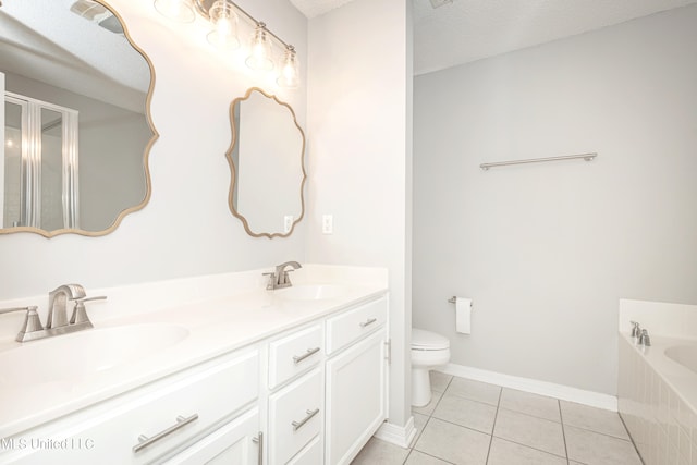 bathroom featuring a textured ceiling, toilet, tile patterned floors, a bathing tub, and vanity