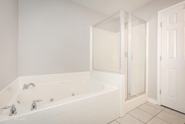 bathroom featuring a textured ceiling, shower with separate bathtub, and tile patterned floors