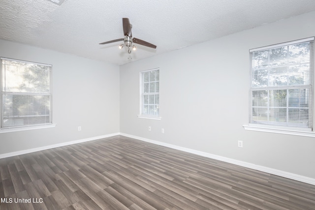 empty room featuring dark wood-type flooring, a textured ceiling, and ceiling fan