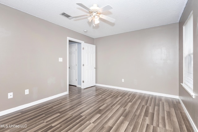 spare room featuring a textured ceiling, hardwood / wood-style flooring, and ceiling fan