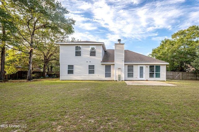 rear view of house featuring a patio area and a lawn