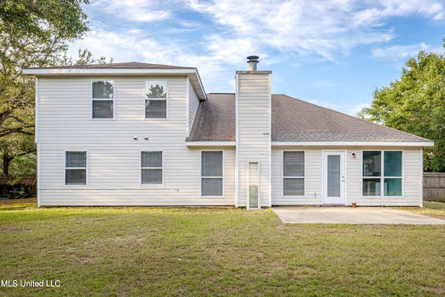 rear view of property featuring a patio area and a yard