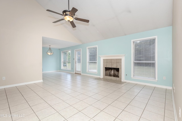 unfurnished living room with high vaulted ceiling, light tile patterned floors, a fireplace, and ceiling fan