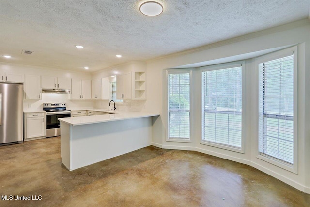 437 Henry Byrd Rd, Florence, MS 39073 - kitchen featuring stainless steel appliances, under cabinet range hood, open shelves, a peninsula, and a textured ceiling