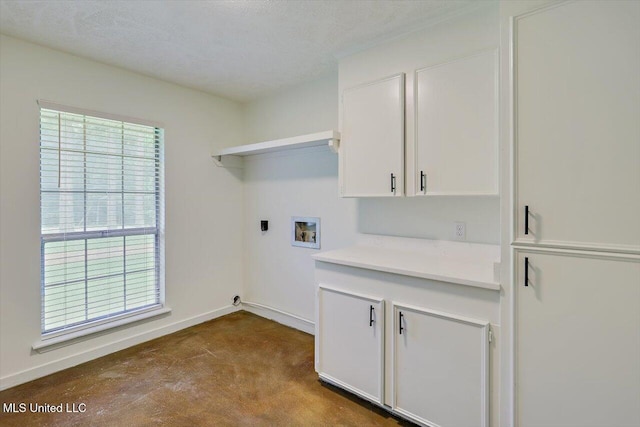 437 Henry Byrd Rd, Florence, MS 39073 - washroom featuring washer hookup, cabinet space, and dark colored carpet
