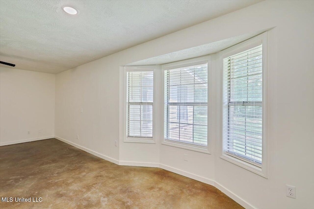 437 Henry Byrd Rd, Florence, MS 39073 - spare room featuring healthy amount of natural light, a textured ceiling, and carpet floors