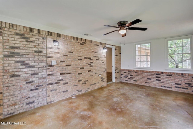 437 Henry Byrd Rd, Florence, MS 39073 - spare room featuring brick wall, concrete floors, and a ceiling fan