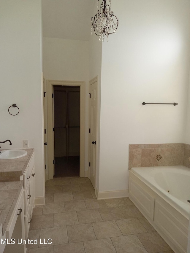 38 3rd St, Cleveland, MS 38732 - bathroom with baseboards, an inviting chandelier, a garden tub, and vanity