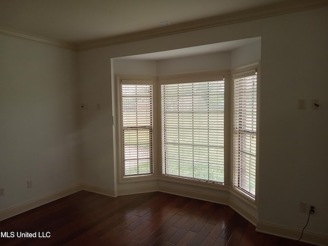 38 3rd St, Cleveland, MS 38732 - unfurnished room featuring baseboards, dark wood finished floors, and a healthy amount of sunlight