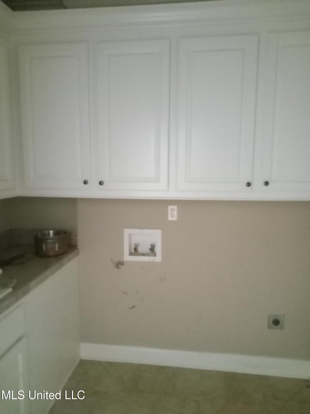 38 3rd St, Cleveland, MS 38732 - washroom with cabinet space, baseboards, electric dryer hookup, and hookup for a washing machine