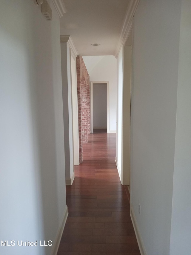 38 3rd St, Cleveland, MS 38732 - corridor featuring baseboards, brick wall, and dark wood-style floors