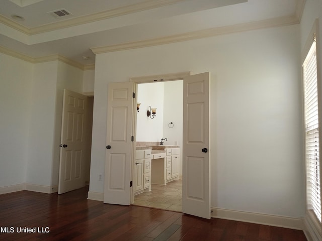 38 3rd St, Cleveland, MS 38732 - unfurnished bedroom featuring wood-type flooring, crown molding, visible vents, baseboards, and a sink