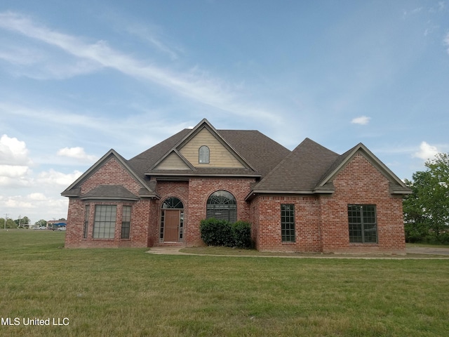 38 3rd St, Cleveland, MS 38732 - traditional-style home with brick siding, a shingled roof, and a front yard