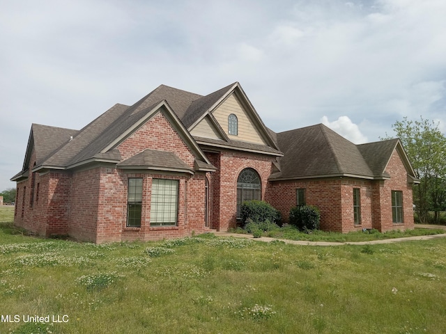 38 3rd St, Cleveland, MS 38732 - traditional-style house with brick siding, a front lawn, and roof with shingles