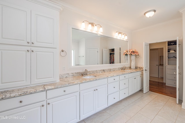 228 Falls Xing, Madison, MS 39110 - bathroom featuring crown molding, double vanity, and a walk in closet