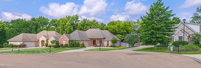 228 Falls Xing, Madison, MS 39110 - view of front of property with concrete driveway, brick siding, an attached garage, and a front yard