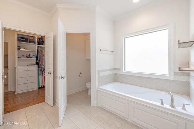 228 Falls Xing, Madison, MS 39110 - full bathroom with a garden tub, toilet, a spacious closet, ornamental molding, and tile patterned floors
