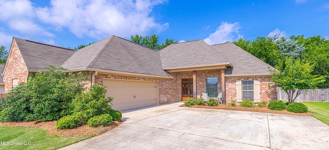 228 Falls Xing, Madison, MS 39110 - view of front of house featuring brick siding, a garage, concrete driveway, and a shingled roof