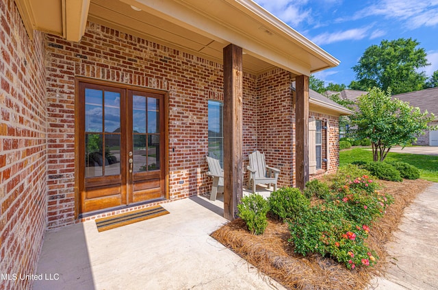 228 Falls Xing, Madison, MS 39110 - view of exterior entry with brick siding and a patio