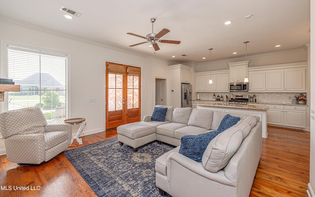 228 Falls Xing, Madison, MS 39110 - living area featuring plenty of natural light, ceiling fan, crown molding, wood finished floors, and recessed lighting