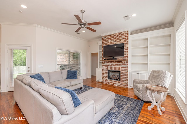 228 Falls Xing, Madison, MS 39110 - living area with ceiling fan, ornamental molding, wood finished floors, a brick fireplace, and recessed lighting