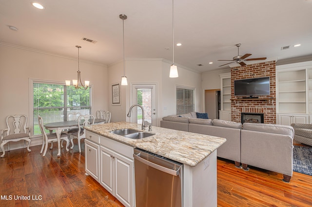 228 Falls Xing, Madison, MS 39110 - kitchen with dishwasher, a sink, a ceiling fan, dark wood-style floors, and a fireplace