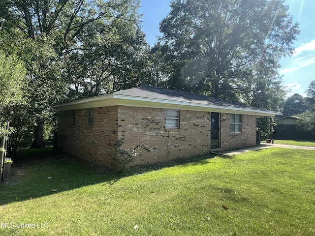 view of side of home featuring a lawn