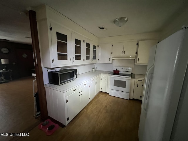 kitchen with white cabinets, white appliances, and dark hardwood / wood-style floors