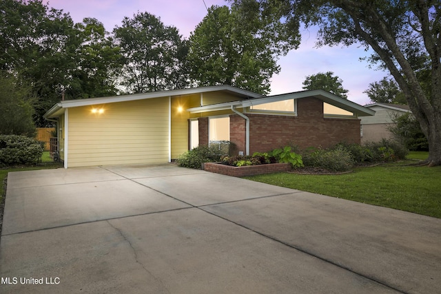 108 Pimlico St, Long Beach, MS 39560 - mid-century modern home featuring driveway, brick siding, and a front yard
