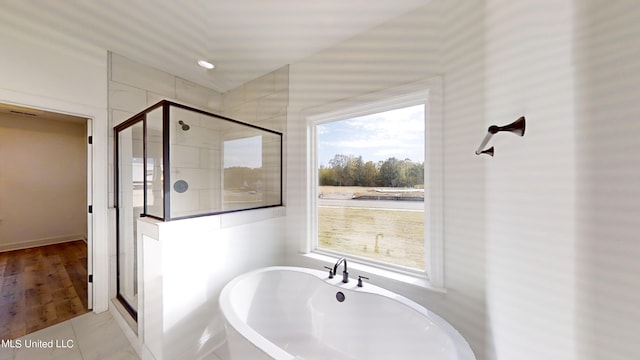 bathroom featuring separate shower and tub and tile patterned flooring