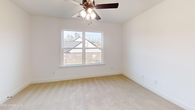 spare room with light colored carpet and ceiling fan