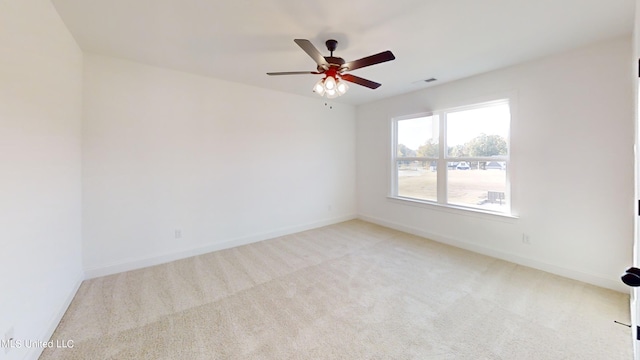 unfurnished room with ceiling fan and light colored carpet