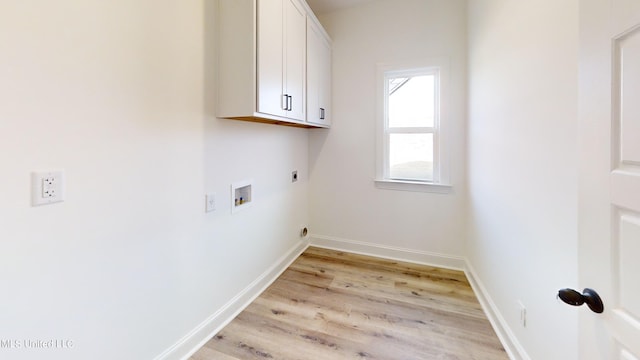 laundry area featuring light hardwood / wood-style floors, electric dryer hookup, washer hookup, and cabinets