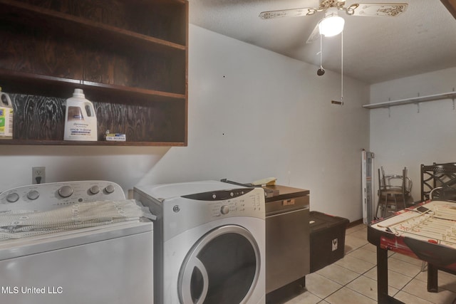 laundry room with laundry area, ceiling fan, light tile patterned floors, and washing machine and clothes dryer