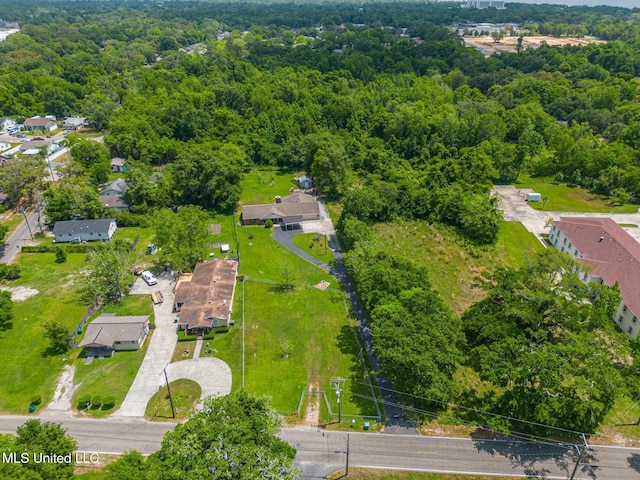 drone / aerial view with a forest view and a residential view