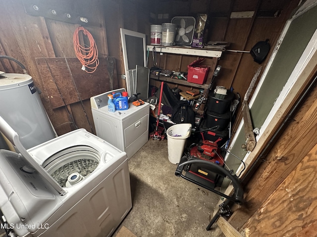 washroom with washer and dryer and water heater